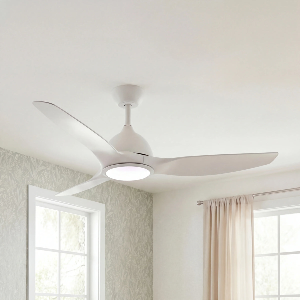 Modern white ceiling fan with integrated LED light in a bright, airy living room