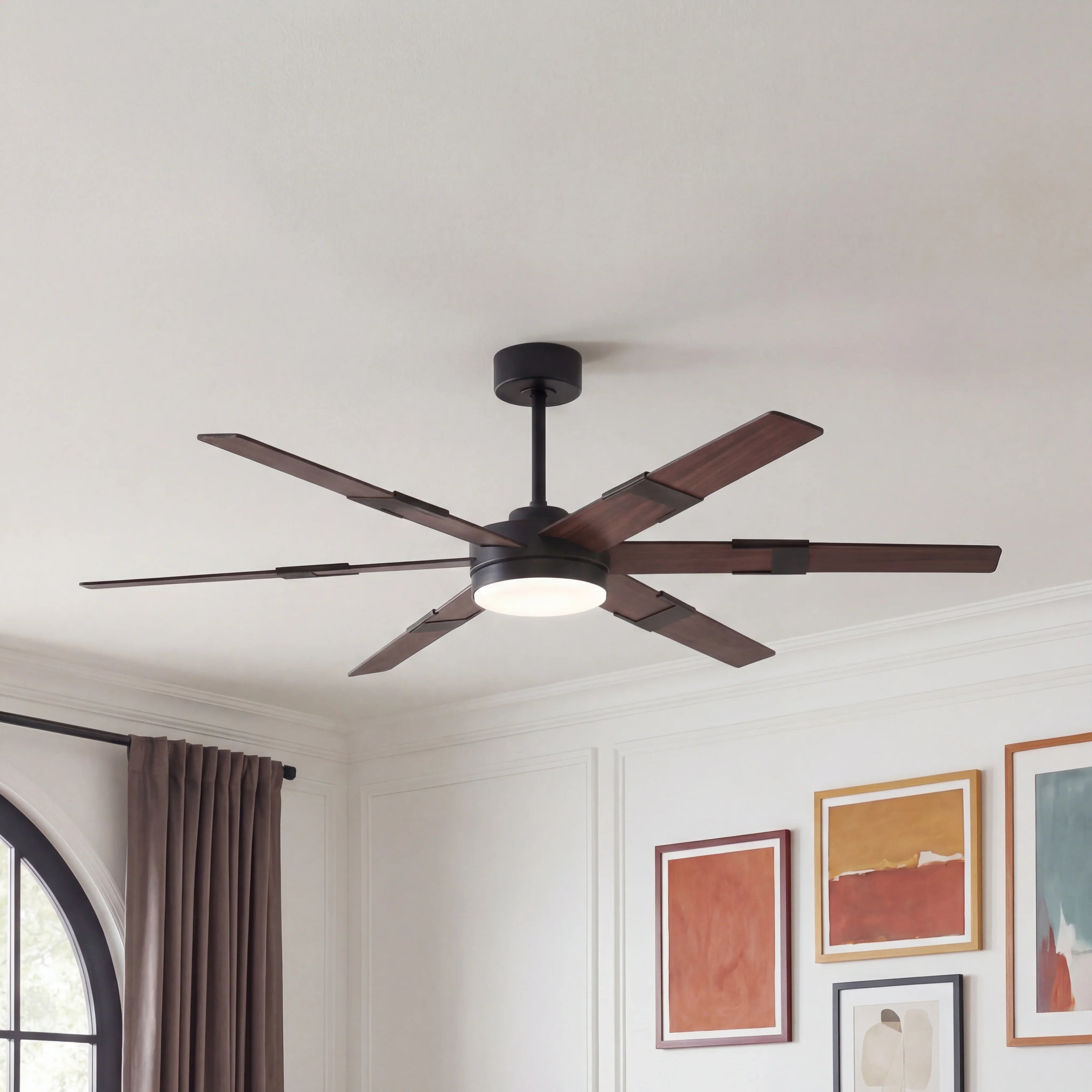 Modern ceiling fan with wood blades and integrated light in a contemporary living room.