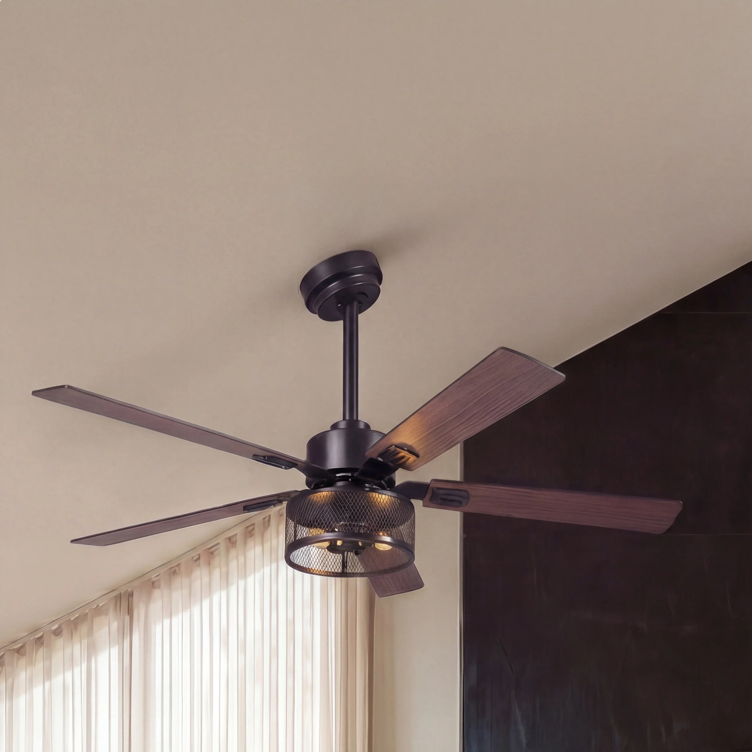 Modern industrial ceiling fan with wood blades and mesh light fixture in living room