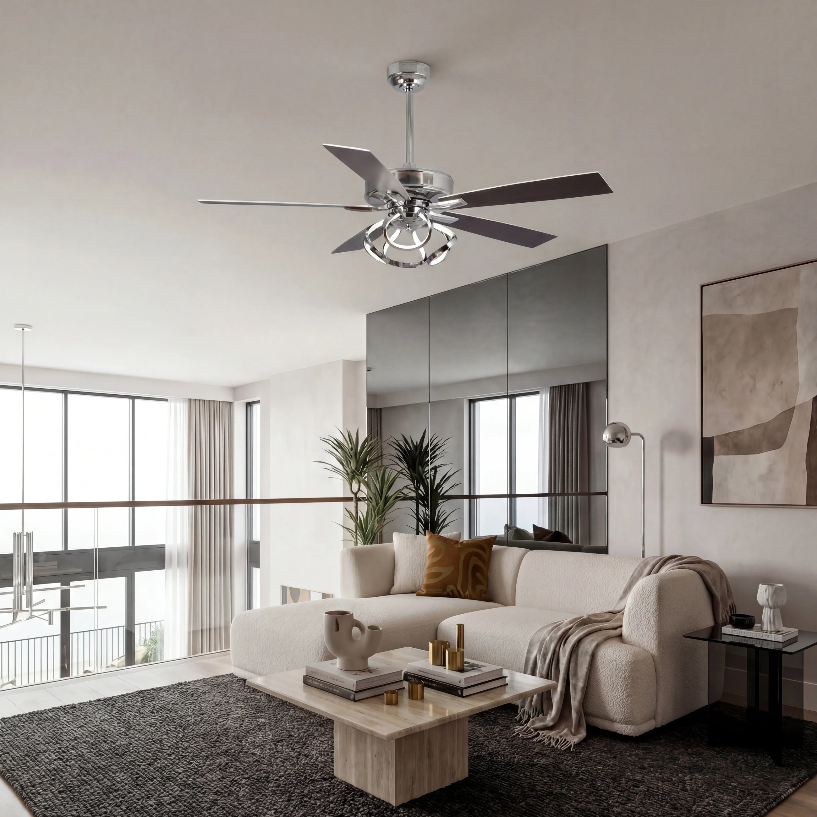 Modern chrome ceiling fan with light in a contemporary living room with neutral decor.