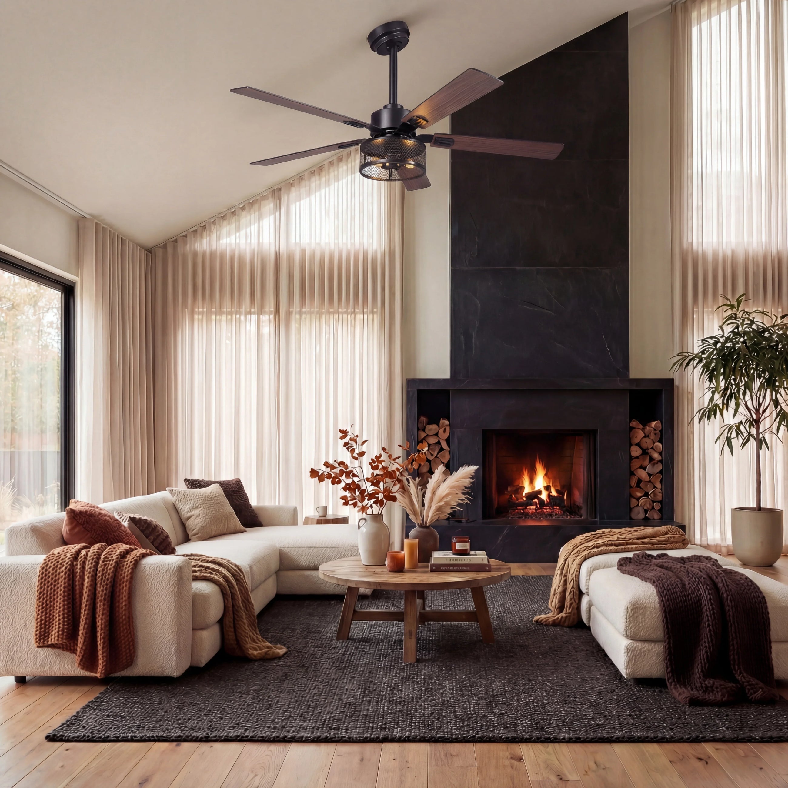 Modern living room with wood ceiling fan, fireplace, light sofas, and cozy decor