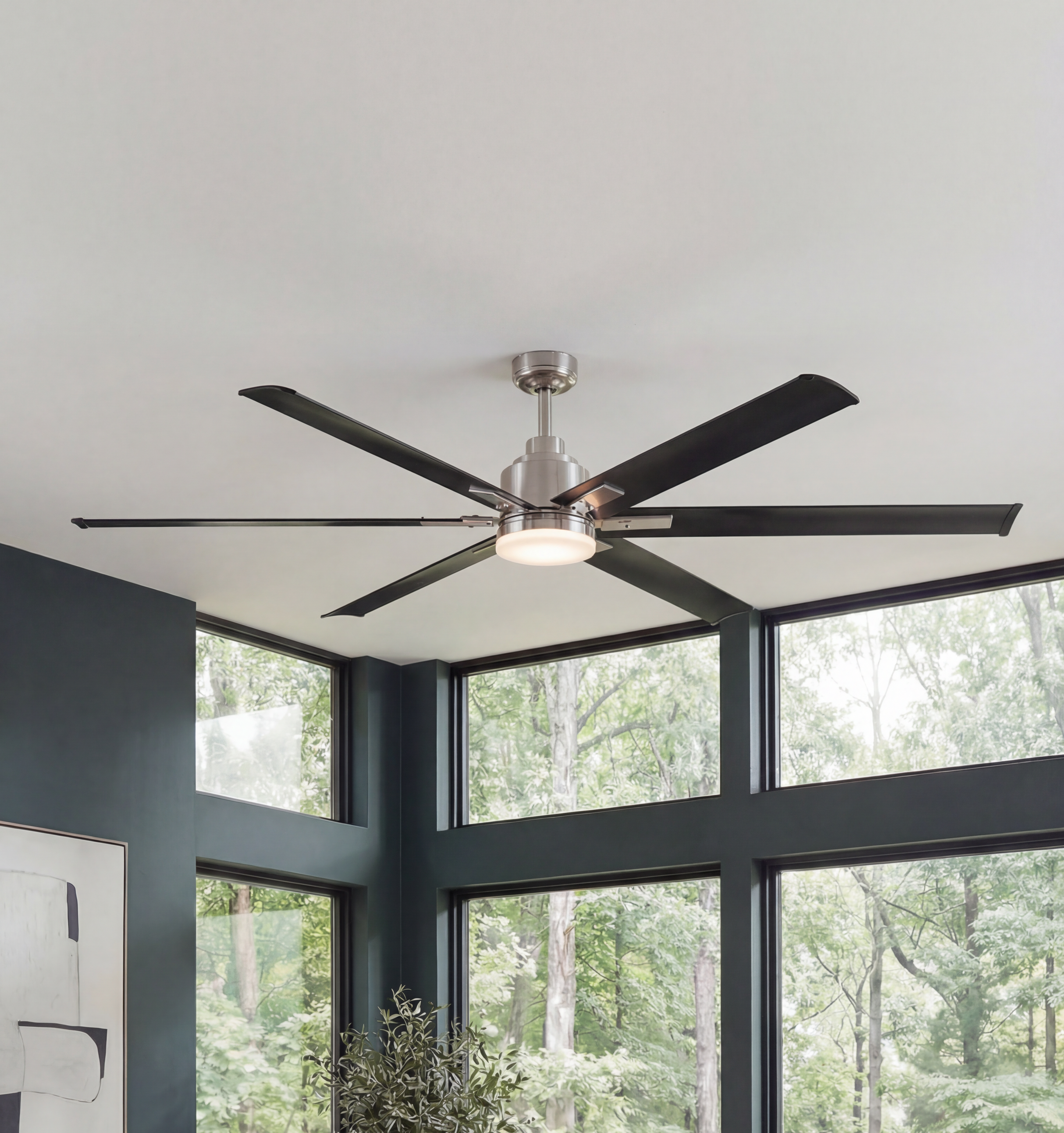 Modern ceiling fan with six dark blades and integrated LED light in a contemporary living room