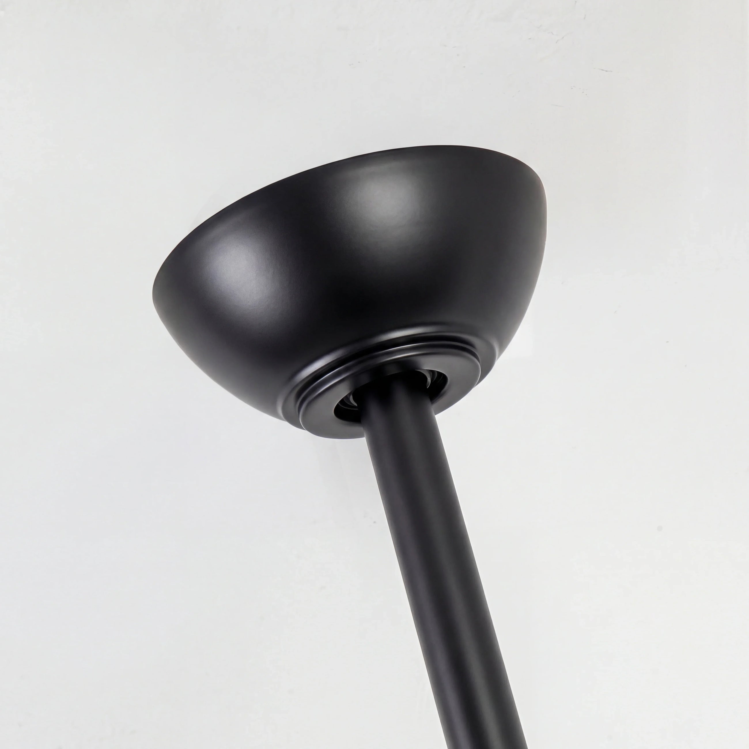 Matte black ceiling fan canopy and downrod on white ceiling, modern home lighting hardware