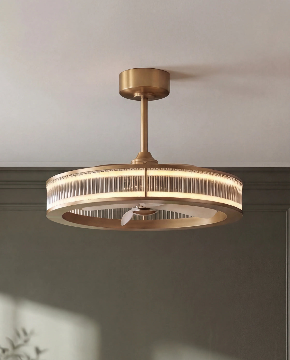 Modern gold fandelier ceiling fan with integrated LED light and crystal accents in a living room