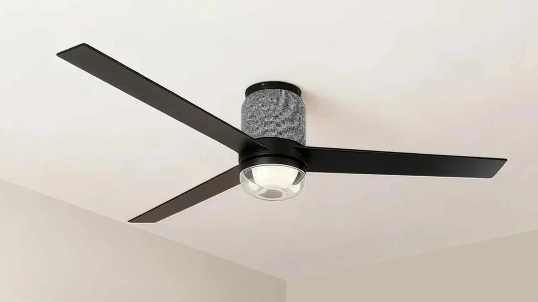 Modern black ceiling fan with three blades and integrated LED light fixture, mounted on white ceiling.