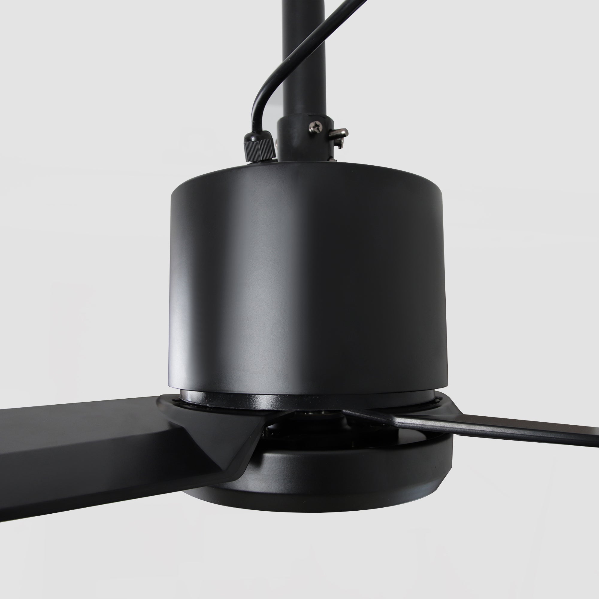 Close-up of modern black ceiling fan with sleek blades and minimalist design