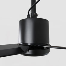 Close-up of modern black ceiling fan with sleek blades and minimalist design