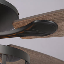 Close-up of modern ceiling fan with wood finish blades and matte black hardware