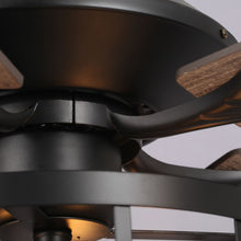 Close-up of modern industrial ceiling fan with black metal housing and wood blades