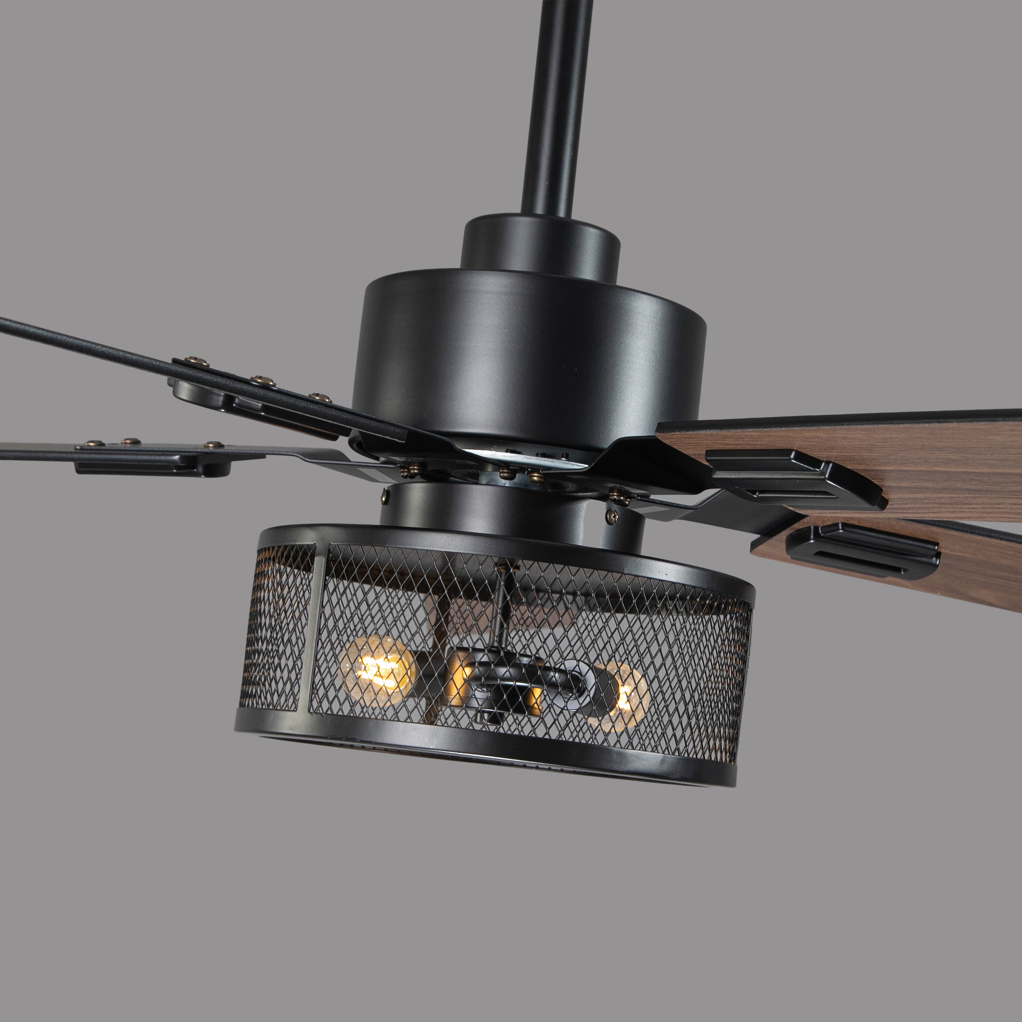 Industrial style ceiling fan with black metal cage light and wood blades, modern design