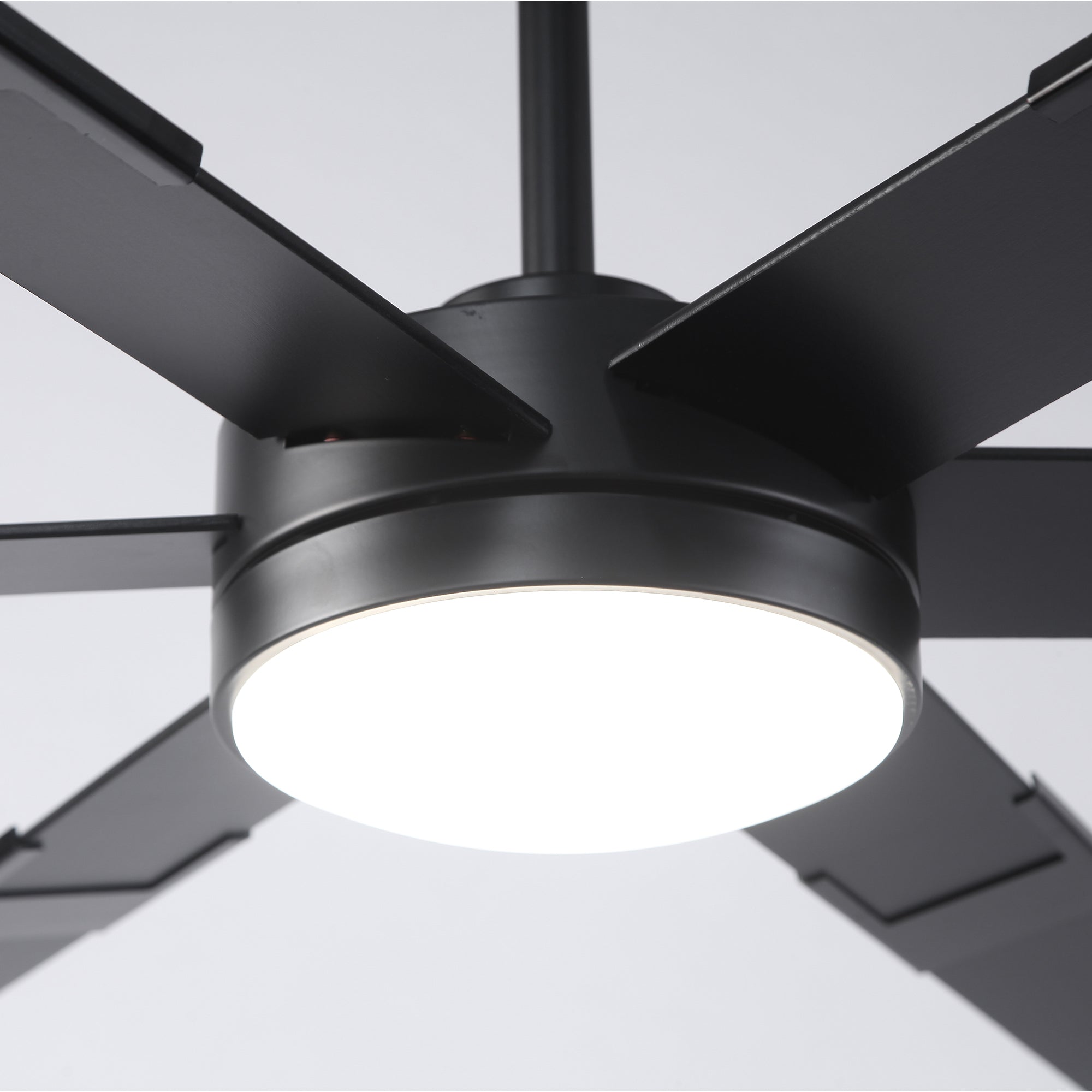 Modern black ceiling fan with LED light, close-up on sleek metal blades and fixture