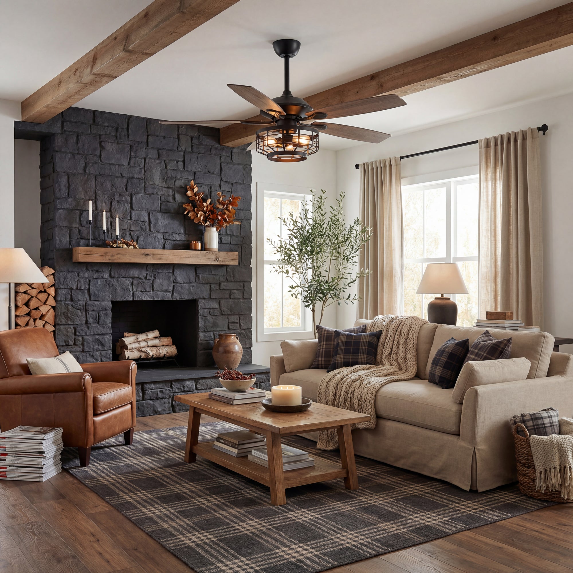 Modern living room with wood ceiling fan, black stone fireplace, and cozy neutral decor