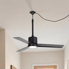 Modern black ceiling fan with integrated LED light in a bright, minimalist room